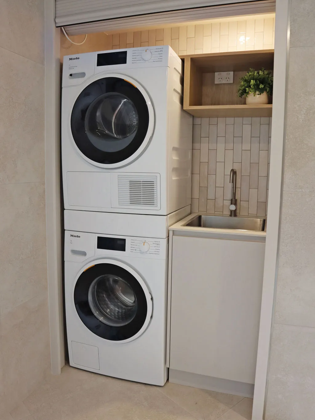 Compact laundry with stacked washer dryer and sink